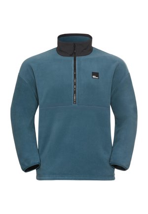 Pulsar fleece trui in teal met een zwarte, ritskraag, voorzien van een frontrits en een logo patch op de borst. Zachte textuur.