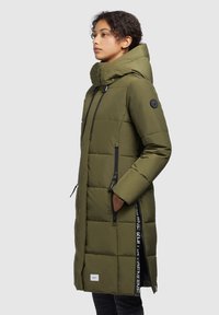 Olive green puffer coat with a hood, zippered pockets, and black accents. Features a quilted design and a snap button closure.