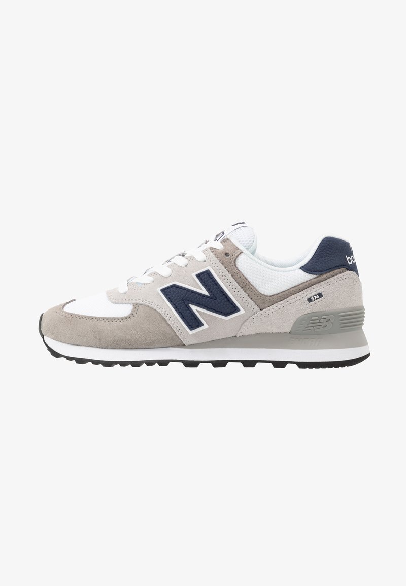 Men's sneaker in gray suede and mesh with white accents. Features a large navy "N" logo, gray heel counter, and black rubber sole.