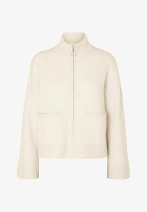 Pull crème court avec col montant, fermeture éclair avant et deux poches avant. Fabriqué en tissu tricoté doux avec des accents côtelés.