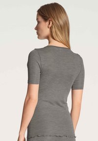 Gray short-sleeve fitted top with a rounded neckline and scalloped hem, crafted from a soft, stretchy fabric. Rear view shown.