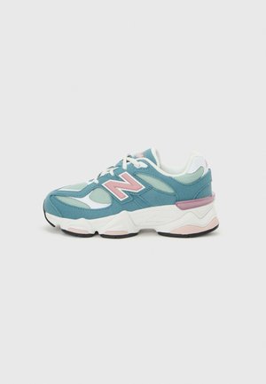 Sneaker with teal suede and mesh panels, pink accents, white laces, and thick white sole with black and pink detailing, side view.
