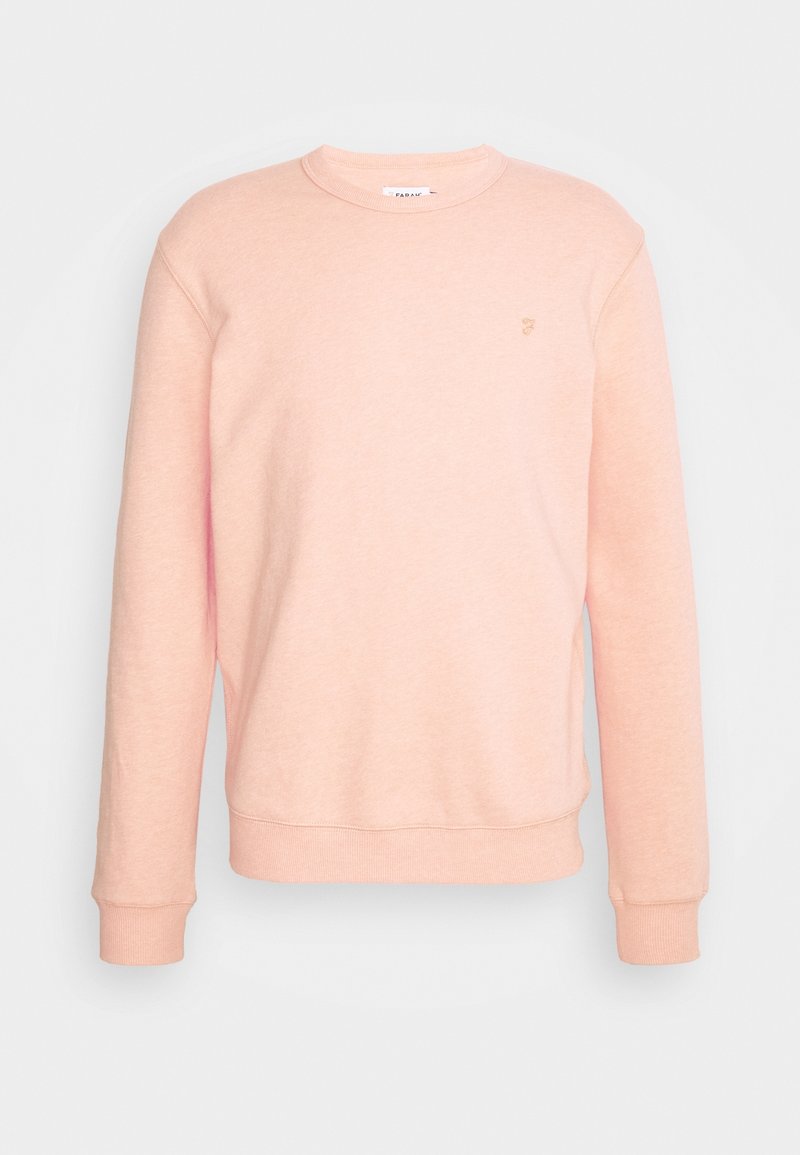 Růžová mikina vyrobená z měkké látky, s kulatým výstřihem, dlouhými rukávy a žebrovanými manžetami, se malým logem na hrudi.