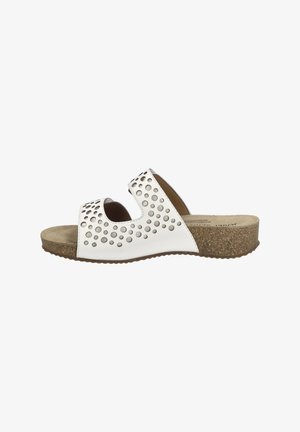 White slide sandals with perforated design, cork footbed, and textured rubber sole. Open-toe style features two cutouts on the upper.