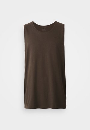 Dark brown sleeveless athletic shirt with a round neckline and a small black Nike logo on the upper left side. Smooth fabric texture.