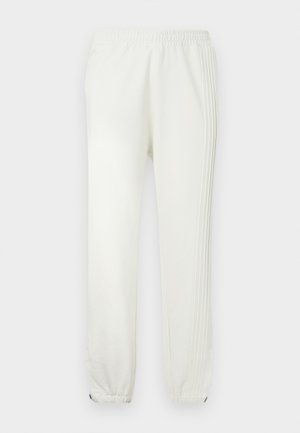 Bijele trenirka hlače s elastičnim pojasom, suženim nogavicama i suptilnim bočnim prugama. Izrađene od mekanog materijala s glatkom teksturom.