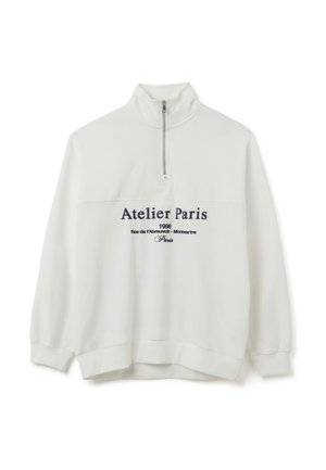 Witte sweatshirt met een hoge kraag en halve rits, met navy tekst "Atelier Paris" en extra details eronder. Katoenen mengsel stof.