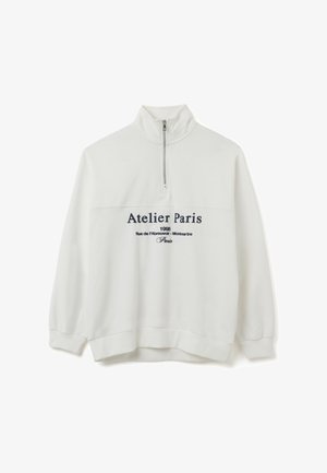 Witte sweatshirt met een hoge kraag en halve rits, met navy tekst "Atelier Paris" en extra details eronder. Katoenen mengsel stof.