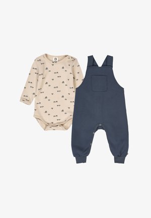 Beige long-sleeve bodysuit with a vehicle pattern, paired with navy blue overalls featuring adjustable straps and a front pocket.