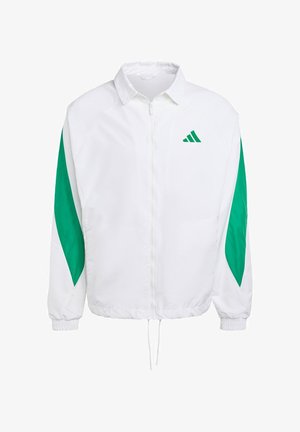 Hvid vindjakke med grønne sidelommer. Har en frontlynlås, elastiske manchetter og snortræk i kanten. Sportsmærkets logo på brystet.