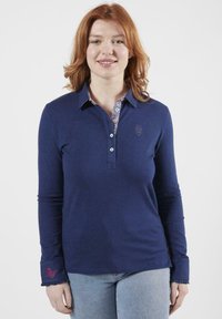 Polo shirt à manches longues marine en coton, avec un col intérieur fleuri, une patte de boutonnage et un détail brodé sur la manche.
