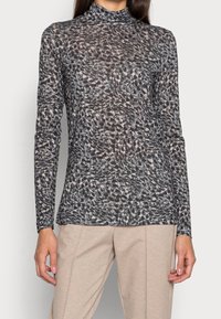 Långärmad topp med hög hals i ett genomskinligt tyg med ett abstrakt mönster i svart och beige. Har en åtsittande siluett och en mjuk textur.