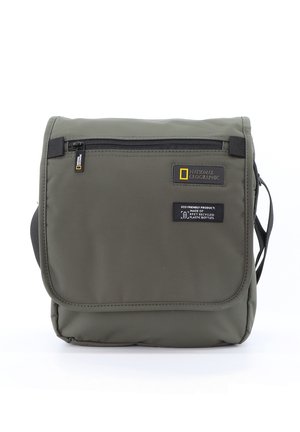 Green nylon shoulder bag with a flap, featuring a zipper pocket, logo, and eco-friendly label. Compact, rectangular design with a shoulder strap.