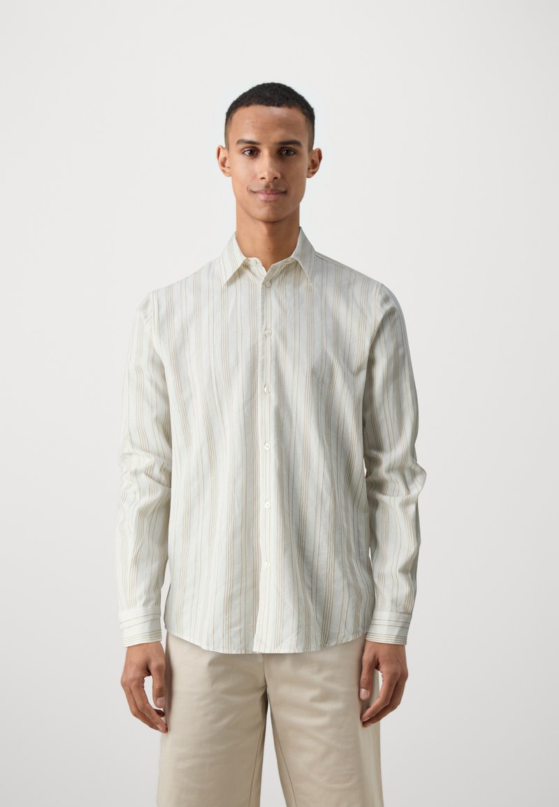 Striped button-up shirt in light beige with thin vertical lines in cream and taupe. Features a classic collar and long sleeves.