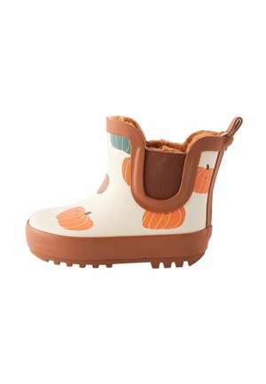 Botte courte marron et crème imperméable avec motif citrouille, doublure intérieure duveteuse et languette à l'arrière.