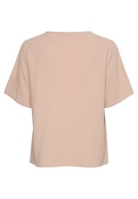 Top rosa chiaro a maniche corte con scollatura rotonda, vestibilità ampia e tessuto a rilievo. L'orlo cade appena sotto la vita.