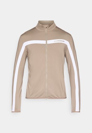 Rjava jakna z zadrgo in visokim ovratnikom, z belimi črtami na straneh in gladko teksturo. Na prsih je natisnjen logotip "J. Lindeberg".