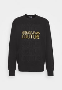 Černá mikina s kulatým výstřihem, na přední straně s vyraženým černým a lesklým zlatým nápisem "VERSACE JEANS COUTURE".