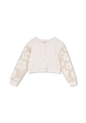 Lichtbeige cropped vestje met knopen aan de voorkant en doorschijnende lange mouwen met witte bloemenpatronen.