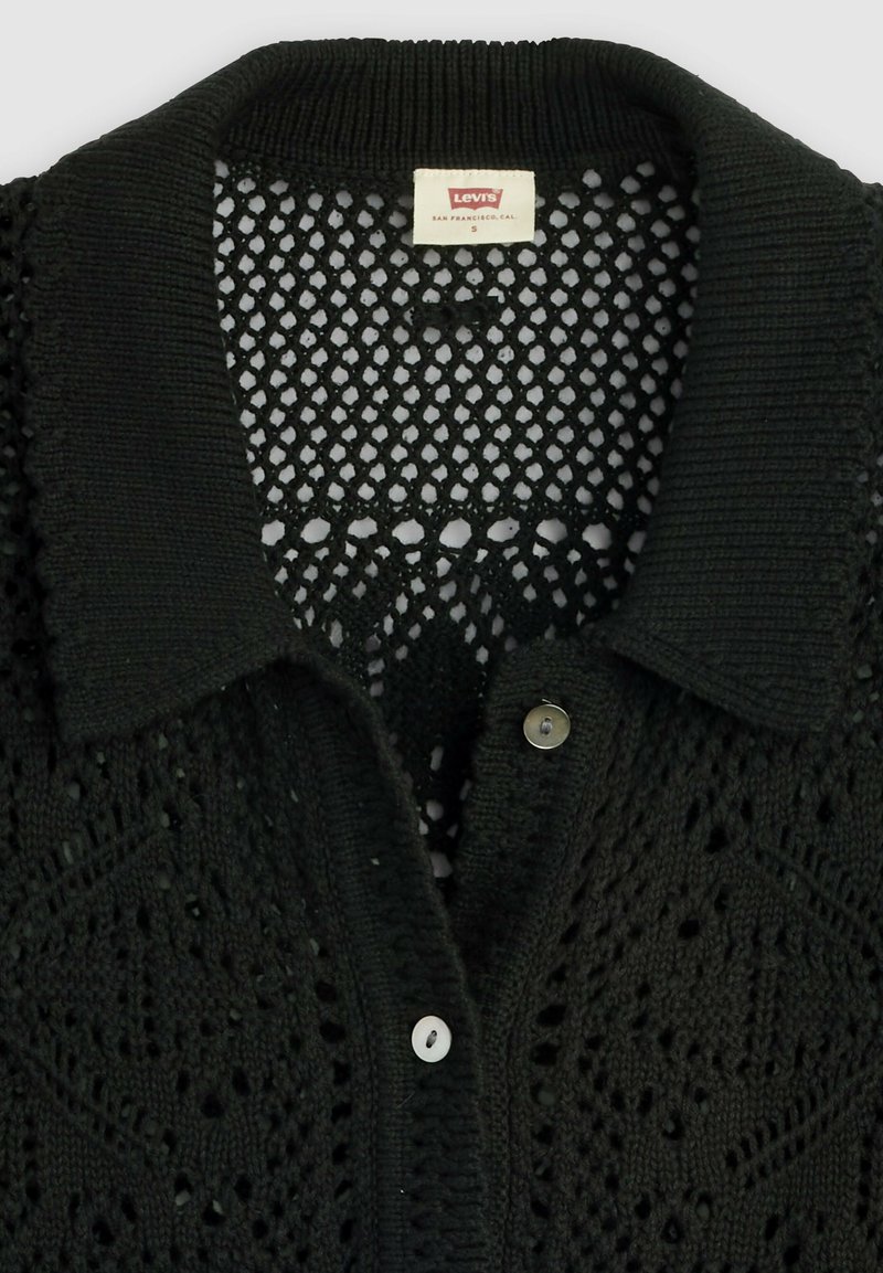 Zwart gebreid shirt met kraag en knoopsluiting, met ingewikkelde open steekpatronen, Levi's-label met maat Small aan de binnenkant van de kraag.