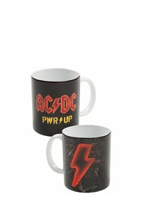 Tazza in ceramica nera con manico bianco, caratterizzata dal logo rosso e giallo degli AC/DC e dal testo "PWR UP" su un lato, e da un design con fulmine rosso sull'altro.