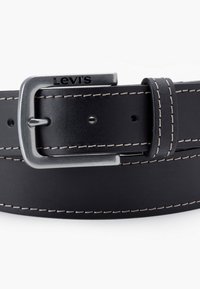 Black leather belt featuring white stitching, a silver metal buckle, and embossed branding. Classic design with standard holes for adjustment.