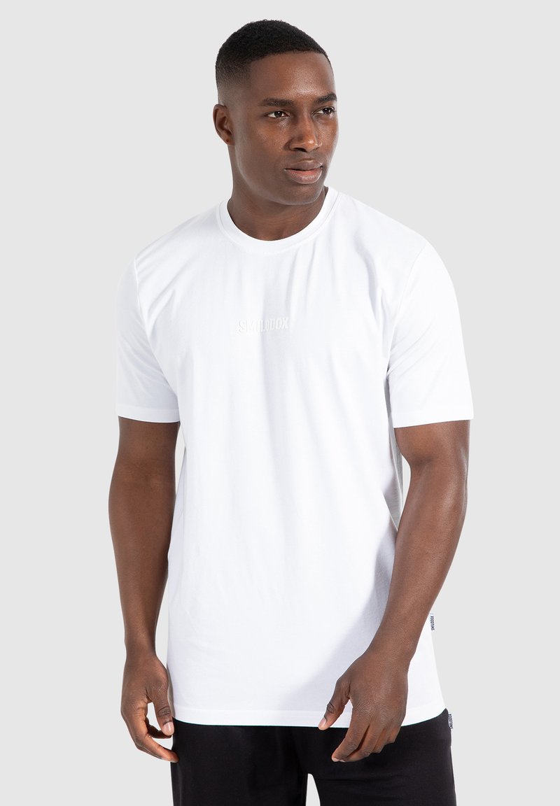 White short-sleeve t-shirt with round neck and a subtle logo in the center. Smooth texture, fitted cut, and a clean, minimalist design.
