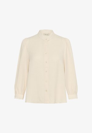 Krém színű gombos blúz, texturált kockás mintával, magas gallérral és ráncolt ujjakra jellemző, csipke díszítéssel a mandzsettán és a gombolásnál.