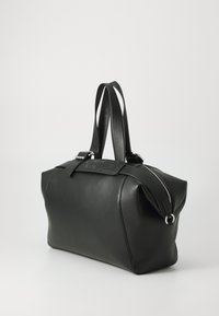 Black leather duffle bag with a structured design, featuring dual handles, a zip closure, and a logo-accented strap. Smooth texture.