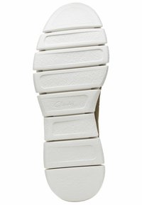 White rubber sole with textured grip patterns and a rounded heel, featuring a slight curve and segmented design for flexibility.