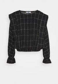 Svart avklippt topp med vitt rutmönster, strukturerat tyg och volangärmar. Har rund halsringning och elastisk fåll.