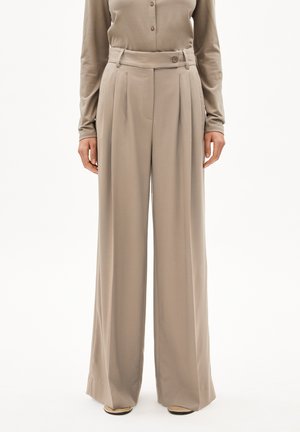 Wide-leg trousers in light beige fabric. Features a high waist, pleats, and a front button detail. Smooth texture with clean lines.