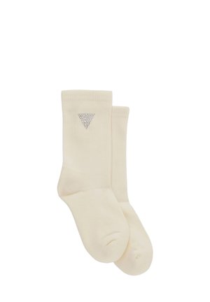 Chaussettes couleur crème avec une texture côtelée et un petit design en triangle argenté sur le côté extérieur. Longueur mi-mollet, tissu doux.