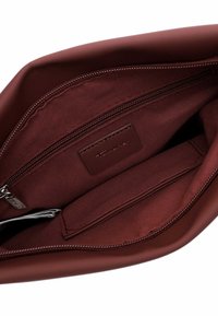 Veinipunase kottisisu, millel on sile kangas, lukuga tasku, logomärk ja eraldi kaartide tasku, kõik puhta õmblusega.