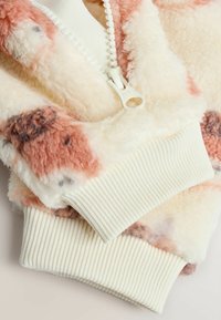 Flauschige Zip-Hoodie in Creme mit rosa und braunen Mustern. Mit gerippten Bündchen und einem weißen Reißverschluss. Weicher, strukturierter Stoff.