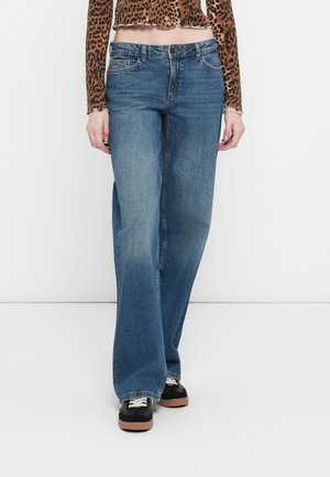 Lys blå vide jeans i denimstoff med en falmet tekstur. Outfiten har en knappelukking foran og fem lommer.