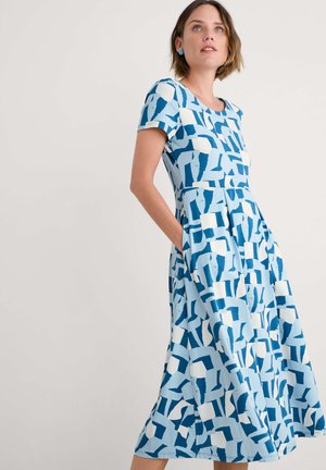 Blue and white patterned cotton dress with short sleeves, a fitted bodice, flared skirt, and side pockets, featuring abstract shapes.
