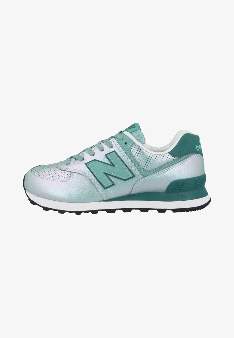 Baskets New Balance basses en argent métallique et bleu sarcelle avec détails perforés et semelle en caoutchouc noire, vue de côté.