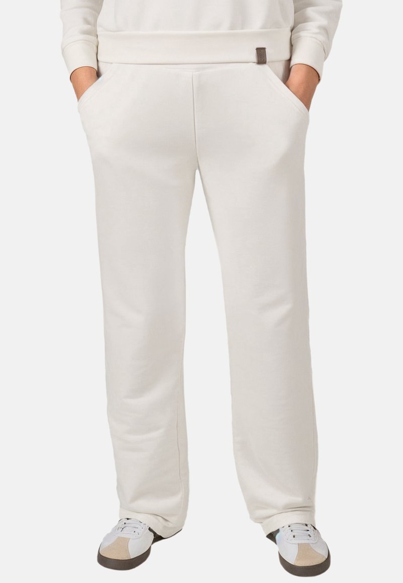Lichtbeige sweatpants van zacht, ademend materiaal; voorzien van zijzakken en een subtiele logopatch; rechte pijpen.