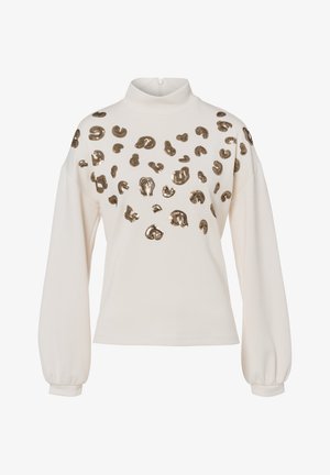 Cremefarbenes Oberteil mit hohem Kragen und langen, aufgepufften Ärmeln, verziert mit metallisch goldenen Leopardenflecken auf der Vorderseite.