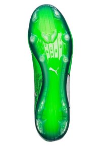 Grön och svart fotbollssko med en strukturerad sula, som har en genomskinlig häl och flera koniska dobbar för bättre grepp.