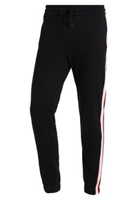 Zwarte sweatpants met een verstelbare tailleband, voorzien van roze en rode zijkanten. De stof is zacht met een gladde textuur en tapert naar de enkels.