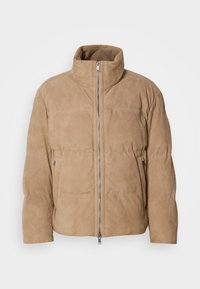 Beige læderjakke med høj krave, glat tekstur og frontlynlås. Har sidelommer og et quiltet design til isolering.