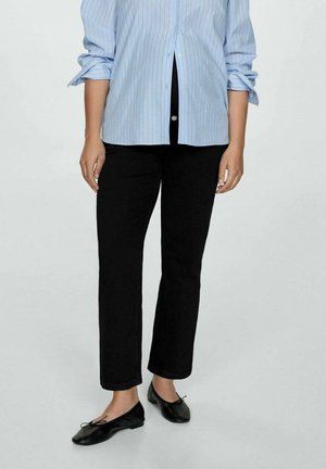 Black straight-leg pants paired with a light blue striped button-up shirt. The fabric appears smooth and soft, with rolled sleeves on the shirt.