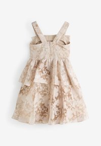Floral-patterned dress in light beige, featuring layered ruffles, wide shoulder straps, and a back zipper closure. Textured sheer overlay.