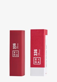 Röd läppstift i ett fyrkantigt rör, matt finish, märk på "336 THE LIPSTICK." Tillsammans med en matchande röd box med vita accenter.