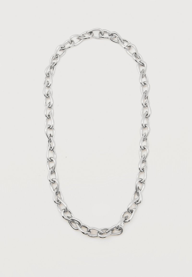 Collier chaîne en métal argenté avec de grands maillons ovales entrelacés formant une boucle allongée sur fond blanc.