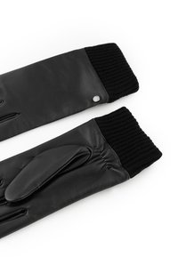 Black leather gloves with ribbed black knit cuffs, featuring a rounded accent near the wrist and a smooth texture. Slim fit design with five fingers.