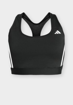 Sutien sport negru cu spate racer, logo Adidas alb în față în dreapta și dungi albe pe părți pe un fundal gri deschis.
