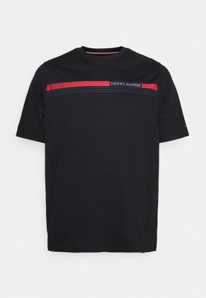 Black short-sleeve Tommy Hilfiger t-shirt with a red and navy stripe across the chest and Tommy Hilfiger logo on the stripe.